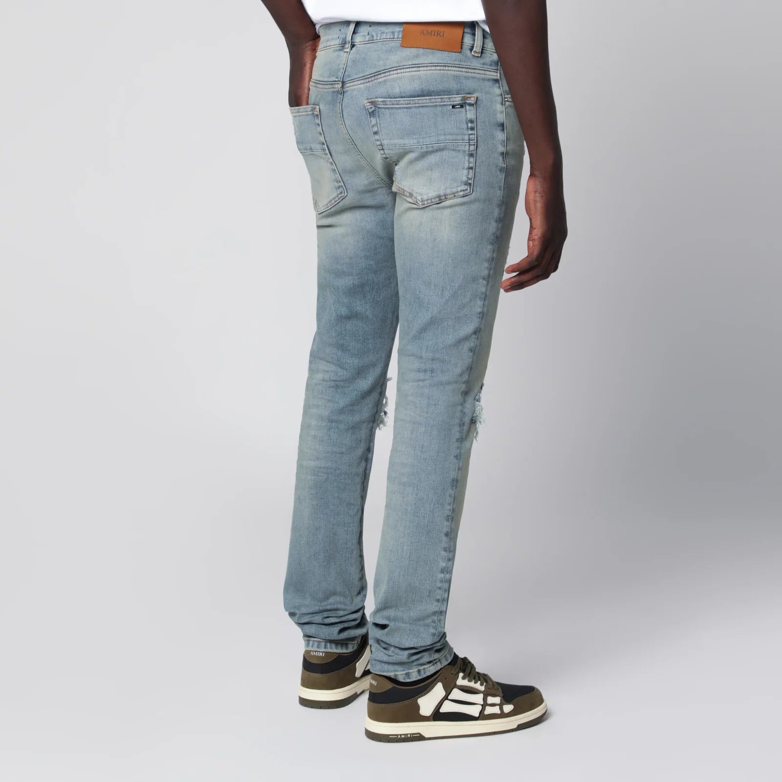AMIRI MX1 distressed flannel-patched jeans in medium indigo